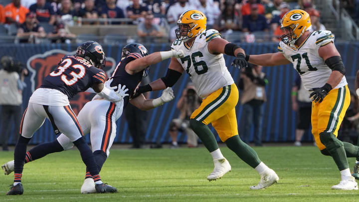 Sep 10, 2023; Chicago, Illinois, USA; Green Bay Packers guard Jon Runyan (76) and center Josh Myers (71) clear a path for running back Aaron Jones (33) during the third quarter of their regular season opening game at Soldier Field.  