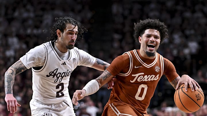 Feb 28, 2026; College Station, Texas, USA; Texas Longhorns guard Jordan Pope (0) reacts as Texas A&M Aggies guard Pop Isaacs (2) applies pressure during the first half at Reed Arena. Mandatory Credit: Maria Lysaker-Imagn Images  