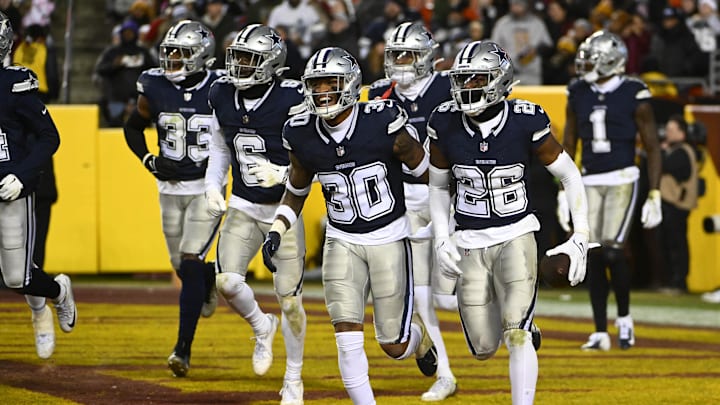 Jan 7, 2024; Landover, Maryland, USA; Dallas Cowboys cornerback DaRon Bland (26) celebrates after intercepting a pass against the Washington Commanders during the second half at FedExField. Mandatory Credit: Brad Mills-Imagn Images