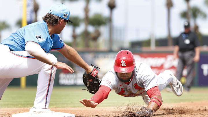 Mar 16, 2025; Jupiter, Florida, USA;  St. Louis Cardinals center fielder Victor Scott II (11) is picked off by Miami Marlins first baseman Jonah Bride (41) during the third inning  at Roger Dean Chevrolet Stadium. Mandatory Credit: Rhona Wise-Imagn Images