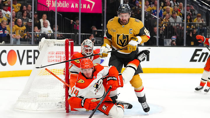 May 4, 2026; Las Vegas, Nevada, USA; Anaheim Ducks defenseman Drew Helleson (14) falls after clearing the puck away from Vegas Golden Knights right wing Mark Stone (61) during the third period of game one of the second round of the 2026 Stanley Cup Playoffs at T-Mobile Arena. Mandatory Credit: Stephen R. Sylvanie-Imagn Images