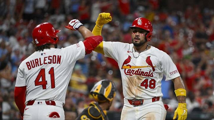 Jul 24, 2025; St. Louis, Missouri, USA;  St. Louis Cardinals designated hitter Ivan Herrera (48) celebrates with left fielder Alec Burleson (41) after hitting a solo home run against the San Diego Padres during the sixth inning at Busch Stadium. Mandatory Credit: Jeff Curry-Imagn Images