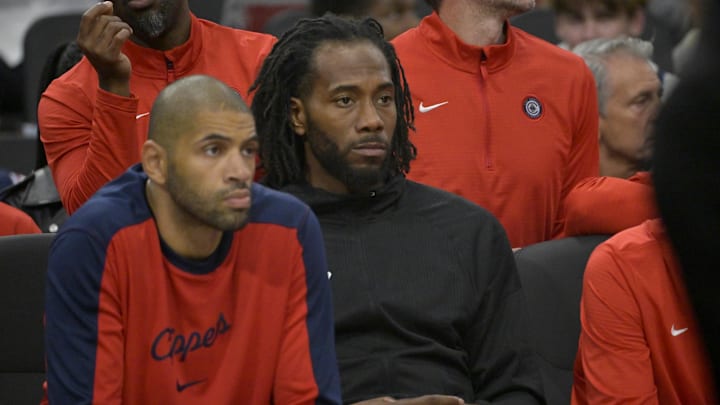 Oct 30, 2024; Inglewood, California, USA;  Los Angeles Clippers forward Kawhi Leonard (2) looks on from the bench as he sits next to forward Nicolas Batum (33) in the first half against the Portland Trail Blazers at Intuit Dome. Mandatory Credit: Jayne Kamin-Oncea-Imagn Images