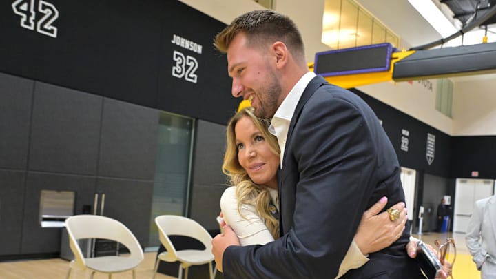 Aug 2, 2025; El Segundo, CA, USA; Los Angeles Lakers Luka Doncic (77) gets a hug from team co-owner Jeanie Buss following a press conference announcing the signing of his contract extension at UCLA Health Training Center. Mandatory Credit: Jayne Kamin-Oncea-Imagn Images