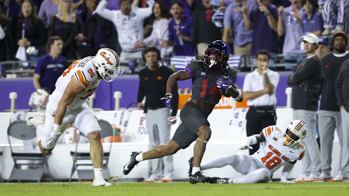 Nov 9, 2024; Fort Worth, Texas, USA;  TCU Horned Frogs wide receiver Jordyn Bailey (14) runs for a touchdown past Oklahoma State Cowboys defensive end Kody Walterscheid (96) and Oklahoma State Cowboys safety David Kabongo (18) during the second half at Amon G. Carter Stadium. Mandatory Credit: Kevin Jairaj-Imagn Images