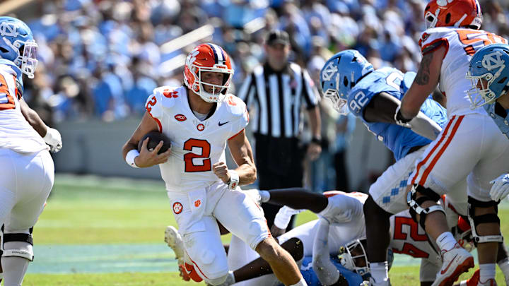 Oct 4, 2025; Chapel Hill, North Carolina, USA; Clemson Tigers quarterback Cade Klubnik (2) with the ball as North Carolina Tar Heels defensive lineman CJ Mims (92) defends in the second quarter at Kenan Stadium. Mandatory Credit: Bob Donnan-Imagn Images