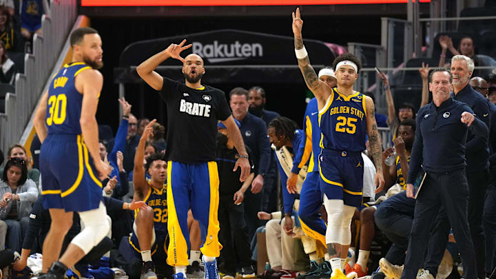Golden State Warriors guards Jerome Robinson and Lester Quinones (25) react after a three point basket by guard Stephen Curry (30).