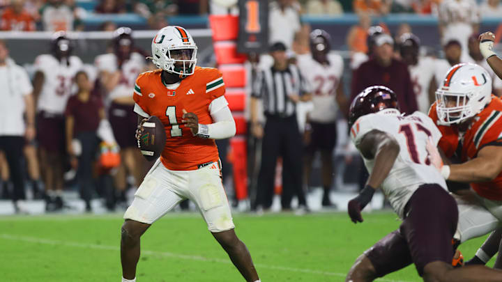 Sep 27, 2024; Miami Gardens, Florida, USA; Miami Hurricanes quarterback Cam Ward (1) looks for a passing option against the Virginia Tech Hokies during the fourth quarter at Hard Rock Stadium. Mandatory Credit: Sam Navarro-Imagn Images