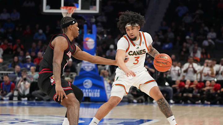 Mar 12, 2026; Charlotte, NC, USA; Miami (FL) Hurricanes guard Tre Donaldson (3) with the ball as Louisville Cardinals guard Ryan Conwell (3) defends in the second half at Spectrum Center. Mandatory Credit: Bob Donnan-Imagn Images