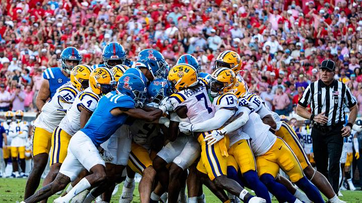 LSU players swarm the Ole Miss offense during a college football game between Ole Miss and LSU at Vaught-Hemingway Stadium in Oxford, Miss., on Saturday, Sept. 27, 2025. Ole Miss defeated LSU 24-19.