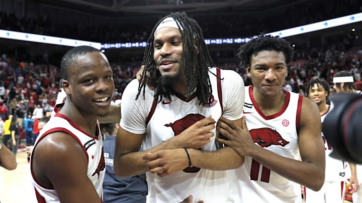 Mar 8, 2025; Fayetteville, Arkansas, USA; Arkansas Razorbacks guard Johnell Davis (1) celebrates with forwards Jonas Aidoo (9) and Karter Knox (11) after the game against the Mississippi State Bulldogs at Bud Walton Arena. Arkansas won 93-92. Mandatory Credit: Nelson Chenault-Imagn Images