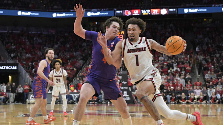 Jan 7, 2025; Louisville, Kentucky, USA; Louisville Cardinals guard J'Vonne Hadley (1) drives to the basket against Clemson Tigers forward Ian Schieffelin (4) during the second half at KFC Yum! Center. Louisville defeated Clemson 74-64. Mandatory Credit: Jamie Rhodes-Imagn Images Jan 7, 2025; Louisville, Kentucky, USA; Louisville Cardinals guard J'Vonne Hadley (1) drives to the basket against Clemson Tigers forward Ian Schieffelin (4) during the second half at KFC Yum! Center. Louisville defeated Clemson 74-64. Mandatory Credit: Jamie Rhodes-Imagn Images