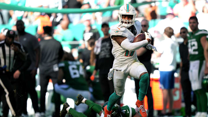 Miami Dolphins wide receiver Jaylen Waddle (17) catches a pass over New York Jets cornerback D.J. Reed (4) for a touchdown during the first half of an NFL game at Hard Rock Stadium in Miami Gardens, Dec. 17, 2023.