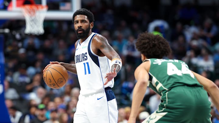 Dallas Mavericks guard Kyrie Irving dribbles as Milwaukee Bucks guard Andre Jackson Jr. defends during the first half at American Airlines Center on Thursday.