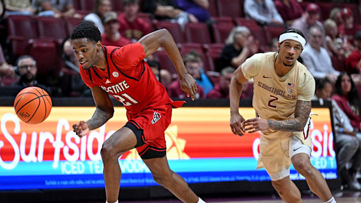 Jan 10, 2026; Tallahassee, Florida, USA; Florida State Seminoles guard Cam Miles (2) loses the ball as North Carolina State Wolfpack guard Terrance Arceneaux (21) picks it up during the second half at Donald L. Tucker Center. Mandatory Credit: Melina Myers-Imagn Images