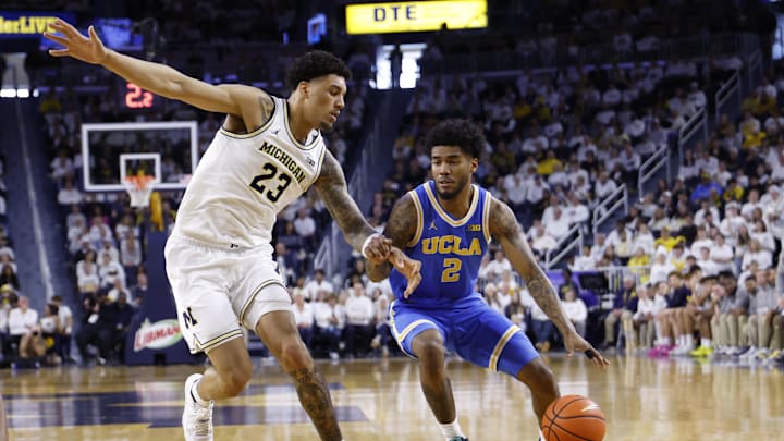 Feb 14, 2026; Ann Arbor, Michigan, USA; UCLA Bruins guard Donovan Dent (2) is defended by Michigan Wolverines forward Yaxel Lendeborg (23) in the second half at Crisler Center. Mandatory Credit: Rick Osentoski-Imagn Images Feb 14, 2026; Ann Arbor, Michigan, USA; UCLA Bruins guard Donovan Dent (2) is defended by Michigan Wolverines forward Yaxel Lendeborg (23) in the second half at Crisler Center. Mandatory Credit: Rick Osentoski-Imagn Images