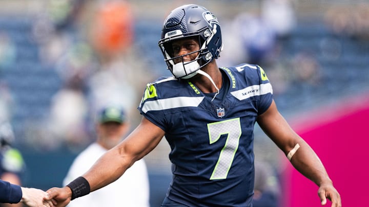 Sep 22, 2024; Seattle, Washington, USA; Seattle Seahawks quarterback Geno Smith (7) high fives a team member before the game against Miami Dolphins at Lumen Field. Mandatory Credit: Kevin Ng-Imagn Images