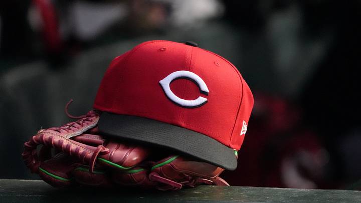 May 5, 2026; Chicago, Illinois, USA; A detail shot of Cincinnati Reds hat and glove in the dugout during the fourth inning against the Chicago Cubs at Wrigley Field. Mandatory Credit: David Banks-Imagn Images