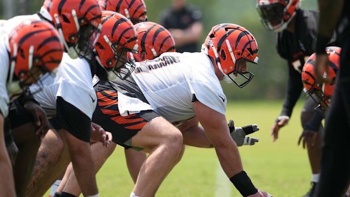 Jun 10, 2025; Cincinnati, OH, USA; Cincinnati Bengals center Ted Karras (64) (center) lines up with the offensive line at the line of scrimmage against the defensive line during practice at Paycor Stadium. Mandatory Credit: Kareem Elgazzar-Imagn Images