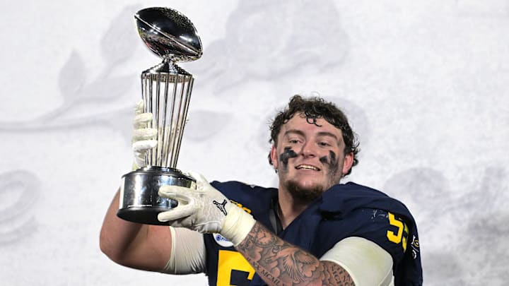 Jan 1, 2024; Pasadena, CA, USA; Michigan Wolverines defensive lineman Mason Graham (55) celebrates with the Leishman Trophy after defeating the Alabama Crimson Tide in the 2024 Rose Bowl college football playoff semifinal game at Rose Bowl. Mandatory Credit: Jayne Kamin-Oncea-Imagn Images