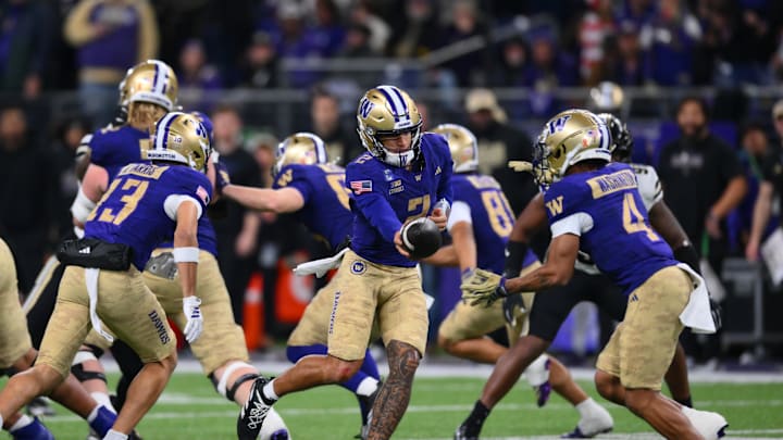 Nov 15, 2025; Seattle, Washington, USA; Washington Huskies quarterback Demond Williams Jr. (2) hands the ball to running back Jordan Washington (4) during the second half at Husky Stadium. Mandatory Credit: Steven Bisig-Imagn Images