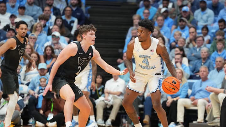 Feb 28, 2026; Chapel Hill, North Carolina, USA; North Carolina Tar Heels guard Jaydon Young (4) with the ball as Virginia Tech Hokies guard Jaden Schutt (2) defends in the first half at Dean E. Smith Center. Mandatory Credit: Bob Donnan-Imagn Images
