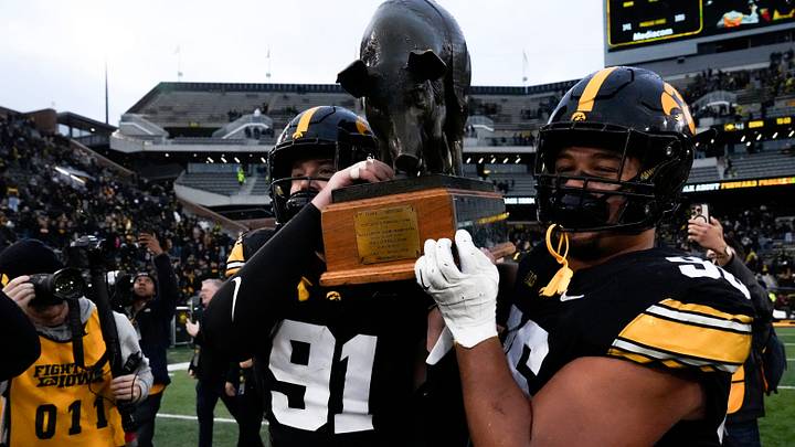Iowa Hawkeyes defensive lineman Jonah Pace (91) and Iowa Hawkeyes defensive lineman Bryce Hawthorne (96) carry the Floyd of Rosedale Trophy after defeating Minnesota Oct. 25, 2025 at Kinnick Stadium in Iowa City, Iowa.