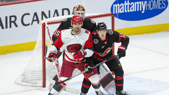 Apr 5, 2026; Ottawa, Ontario, CAN; Carolina Hurricanes left wing William Carrier (28) and Ottawa Senators defenseman Jordan Spence (19) jockey for position in front of goalie Linus Ullmark (35) in the third period at the Canadian Tire Centre. Mandatory Credit: Marc DesRosiers-IMAGN Images