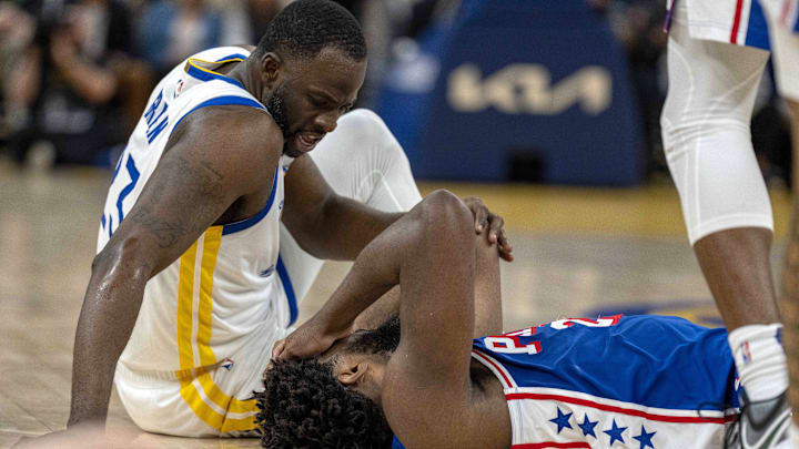 Jan 30, 2024; San Francisco, California, USA;  Golden State Warriors forward Draymond Green (23) checks on Philadelphia 76ers center Joel Embiid (21) after a play during the second quarter at Chase Center. Mandatory Credit: Neville E. Guard-Imagn Images