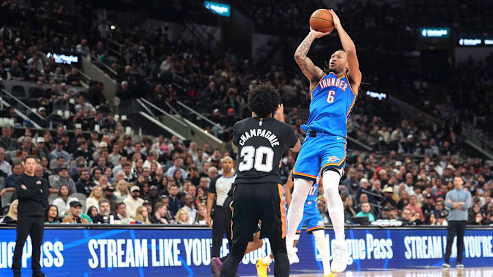 Feb 4, 2026; San Antonio, Texas, USA; Oklahoma City Thunder forward Jaylin Williams (6) shoots over San Antonio Spurs forward Julian Champagnie (30) during the second half at Frost Bank Center. Mandatory Credit: Scott Wachter-Imagn Images