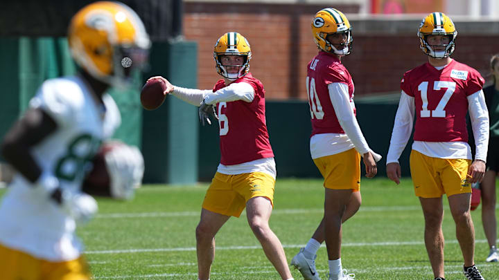 Green Bay Packers quarterback Sean Clifford fires a pass alongside Jordan Love during OTAs in May.