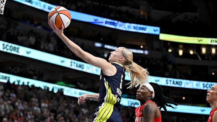 Dallas Wings guard Paige Bueckers (5) drives to the basket against the Indiana Fever during the first quarter at the American Airlines Center. Dallas Wings guard Paige Bueckers (5) drives to the basket against the Indiana Fever during the first quarter at the American Airlines Center.