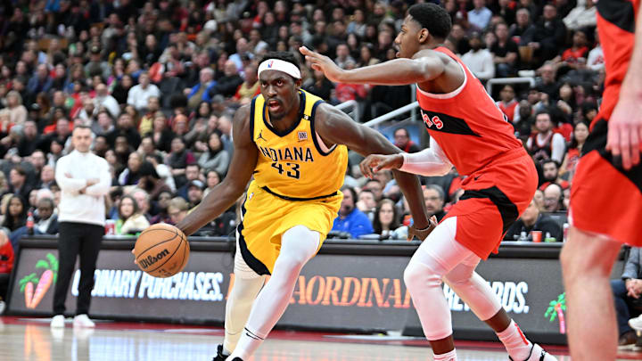 Feb 14, 2024; Toronto, Ontario, CAN;  Indiana Pacers forward Pascal Siakam (43) dribbles the ball past Toronto Raptors forward RJ Barrett (9) in the first half at Scotiabank Arena. Mandatory Credit: Dan Hamilton-USA TODAY Sports