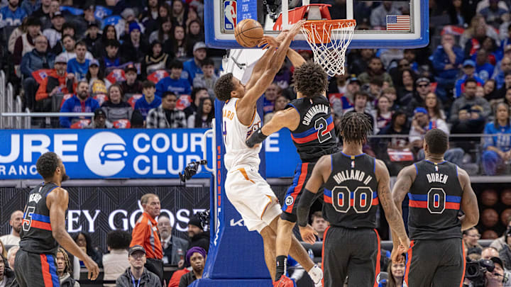 Jan 18, 2025; Detroit, Michigan, USA; Detroit Pistons guard Cade Cunningham (2) blocks a dunk attempt by Phoenix Suns center Nick Richards (4) during the second quarter at Little Caesars Arena. Mandatory Credit: David Reginek-Imagn Images