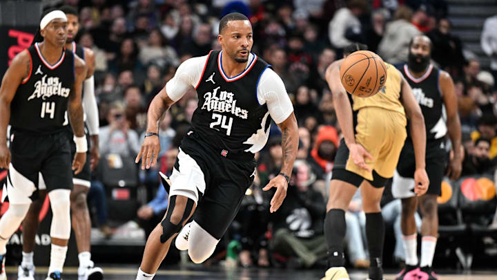 Jan 26, 2024; Toronto, Ontario, CAN;   Los Angeles Clippers guard Norman Powell (24) plays for the ball against the Toronto Raptors in the second half at Scotiabank Arena. Mandatory Credit: Dan Hamilton-Imagn Images