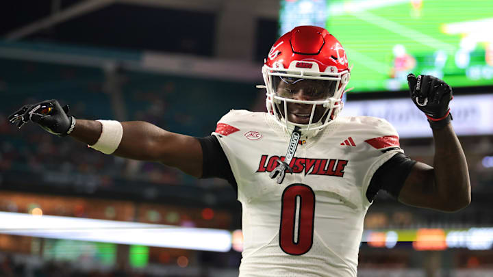 Oct 17, 2025; Miami Gardens, Florida, USA; Louisville Cardinals wide receiver Chris Bell (0) celebrates after scoring a touchdown against the Miami Hurricanes during the first quarter at Hard Rock Stadium. Mandatory Credit: Sam Navarro-Imagn Images