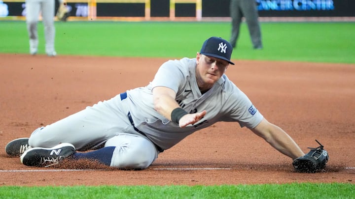 Jun 10, 2024; Kansas City, Missouri, USA; New York Yankees first baseman DJ LeMahieu (26) stops a line drive down the first base line against the Kansas City Royals in the fifth inning at Kauffman Stadium. Mandatory Credit: Denny Medley-USA TODAY Sports