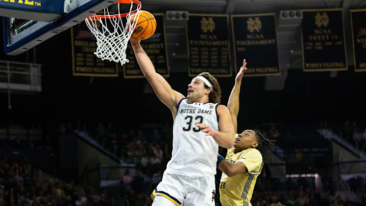 Feb 14, 2026; South Bend, Indiana, USA; Notre Dame Fighting Irish forward Carson Towt (33) drives to the basket as Georgia Tech Yellow Jackets guard Akai Fleming (0) defends during the first half at Purcell Pavilion at the Joyce Center.