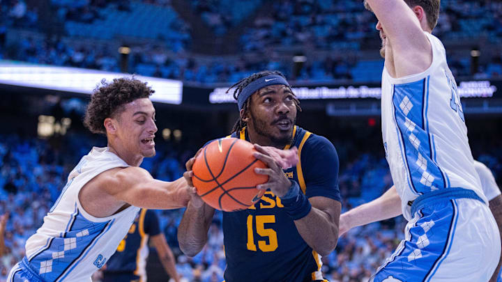 Dec 16, 2025; Chapel Hill, North Carolina, USA; ETSU Buccaneers forward Cam Morris III (15) gets fouled by North Carolina Tar Heels guard Kyan Evans (0) during the first half at Dean E. Smith Center. Mandatory Credit: Scott Kinser-Imagn Images