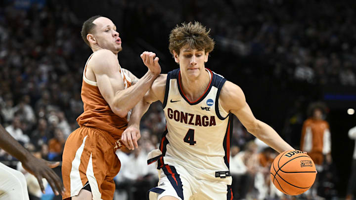 Mar 21, 2026; Portland, OR, USA; Gonzaga Bulldogs guard Davis Fogle (4) drives against Texas Longhorns guard Chendall Weaver (2) in the second half during a second round game of the men's 2026 NCAA Tournament at Moda Center. Mandatory Credit: Craig Strobeck-Imagn Images