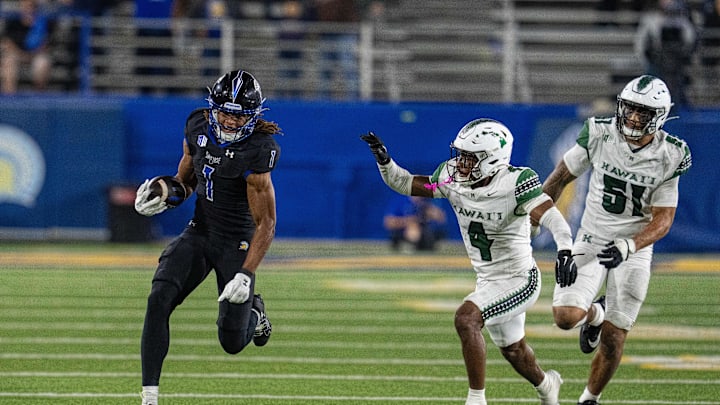 Nov 1, 2025; San Jose, California, USA; San Jose State Spartans wide receiver Leland Smith (1) runs for a first down against Hawaii Rainbow Wahine defensive back Elijah Palmer (4) during the fourth quarter at CEFCU Stadium. Mandatory Credit: Neville E. Guard-Imagn Images