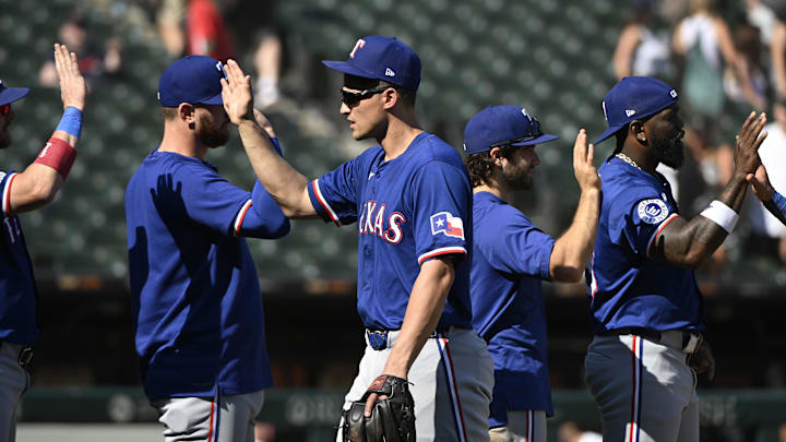 Aug 29, 2024; Chicago, Illinois, USA;  Texas Rangers shortstop Corey Seager (5) celebrates with teammates after the game against the Chicago White Sox at Guaranteed Rate Field. 