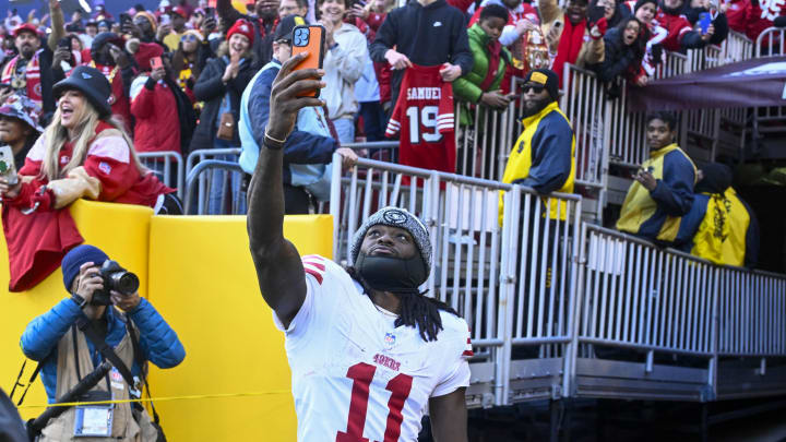 Dec 31, 2023; Landover, Maryland, USA; San Francisco 49ers wide receiver Brandon Aiyuk (11) celebrates with fans after defeating the Washington Commanders at FedExField. Mandatory Credit: Brad Mills-USA TODAY Sports Dec 31, 2023; Landover, Maryland, USA; San Francisco 49ers wide receiver Brandon Aiyuk (11) celebrates with fans after defeating the Washington Commanders at FedExField. Mandatory Credit: Brad Mills-USA TODAY Sports