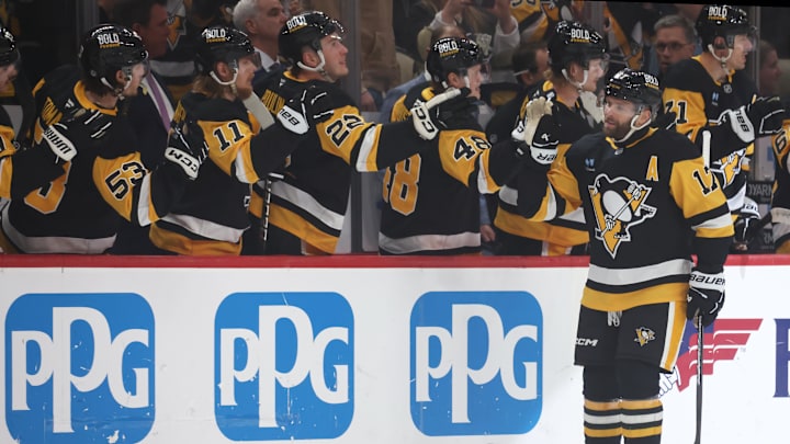 Apr 17, 2025; Pittsburgh, Pennsylvania, USA;  Pittsburgh Penguins right wing Bryan Rust (17) celebrates his goal with the Penguins bench against the Washington Capitals during the first period at PPG Paints Arena. Mandatory Credit: Charles LeClaire-Imagn Images