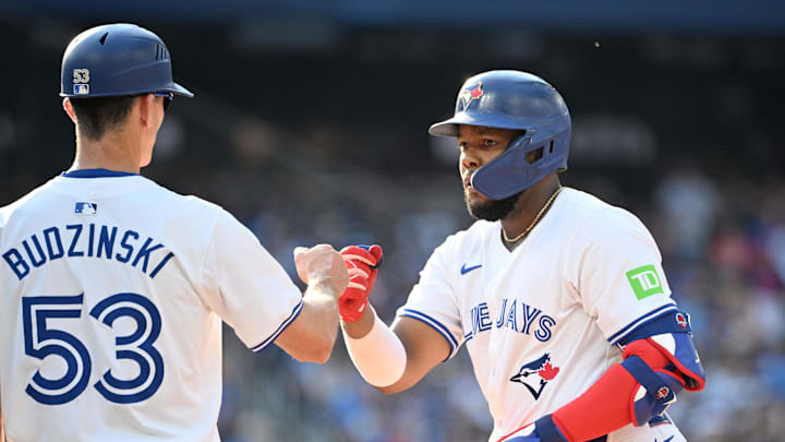 Toronto Blue Jays first baseman Vladimir Guerrero Jr. (27) is greeted by first base coach Mark Budzinski (53) after hitting an RBI single against the St. Louis Cardinals in the seventh inning at Rogers Centre. It was the 500th RBI of his career in 2024. Toronto Blue Jays first baseman Vladimir Guerrero Jr. (27) is greeted by first base coach Mark Budzinski (53) after hitting an RBI single against the St. Louis Cardinals in the seventh inning at Rogers Centre. It was the 500th RBI of his career in 2024.