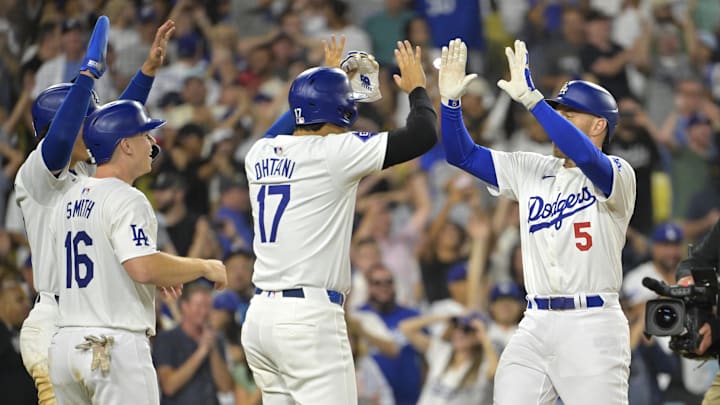 Jul 19, 2024; Los Angeles, California, USA;  Los Angeles Dodgers first base Freddie Freeman (5) is congratulated by designated hitter Shohei Ohtani (17), catcher Will Smith (16) and outfielder Miguel Vargas (27) after hitting a grand slam home run in the eighth inning against the Boston Red Sox at Dodger Stadium. Mandatory Credit: Jayne Kamin-Oncea-Imagn Images