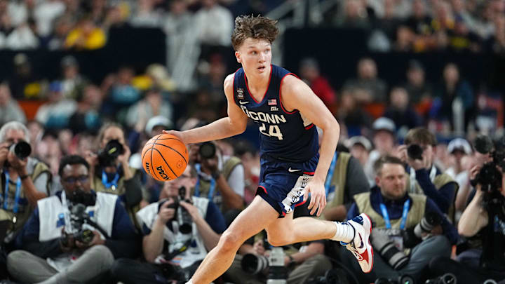Apr 6, 2026; Indianapolis, IN, USA; UConn Huskies guard Braylon Mullins (24) dribbles the ball against the Michigan Wolverines during the first half in the national championship of the Final Four of the men's 2026 NCAA Tournament between the  and the Michigan Wolverines at Lucas Oil Stadium.