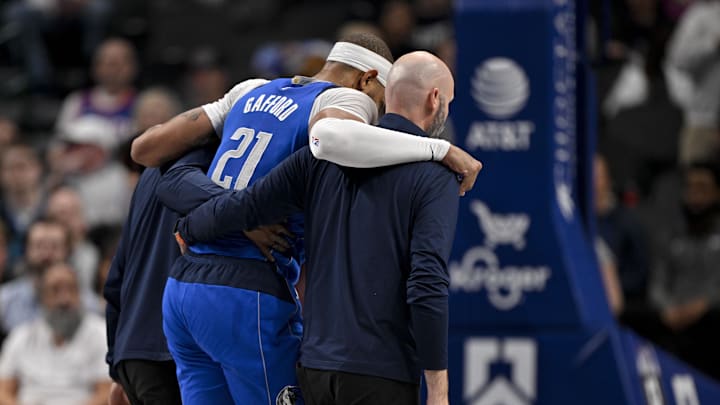 Feb 10, 2025; Dallas, Texas, USA; Dallas Mavericks center Daniel Gafford (21) is helped off the court during the second quarter against the Sacramento Kings at the American Airlines Center. Mandatory Credit: Jerome Miron-Imagn Images