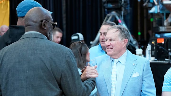 Mar 8, 2025; Chapel Hill, North Carolina, USA;  Former North Carolina Tar Heels great Lawrence Taylor with head football coach Bill Bellichick together during a time out in the first half at Dean E. Smith Center. Mandatory Credit: Bob Donnan-Imagn Images
