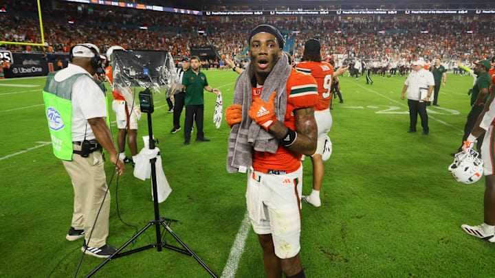 Sep 27, 2024; Miami Gardens, Florida, USA; Miami Hurricanes wide receiver Samuel Brown (11) reacts as he watches the video board from the field during an official review of the final play of the game against the Virginia Tech Hokies at Hard Rock Stadium. Mandatory Credit: Sam Navarro-Imagn Images